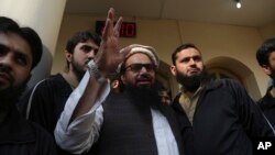 Hafiz Saeed, head of the Pakistan's Jamaat-ud-Dawa group waves to supporters at a mosque in Lahore, Pakistan, Nov. 24, 2017.