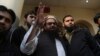 FILE - Hafiz Saeed, head of the Pakistan's Jamaat-ud-Dawa group, waves to supporters at a mosque in Lahore, Pakistan, Nov. 24, 2017.