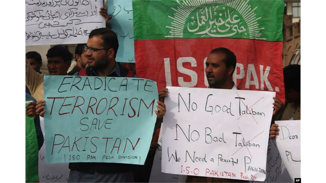 FILE - People protest against an Islamic State-claimed attack on a shrine earlier this year, in Peshawar, Pakistan, Feb. 17, 2017.