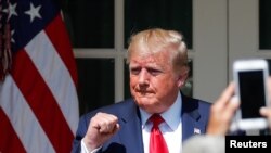 U.S. President Donald Trump pumps his fist during a signing ceremony for the "Permanent Authorization of the September 11th Victim Compensation Fund Act" in the Rose Garden of the White House in Washington, U.S., July 29, 2019. 