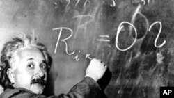 FILE - Dr. Albert Einstein writes out an equation for the density of the Milky Way on the blackboard at the Carnegie Institute, Mt. Wilson Observatory headquarters in Pasadena, Calif., Jan. 14, 1931