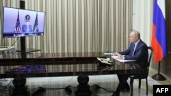 Vladimir Putin attends a meeting with US President Joe Biden