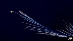 An Indian Air Force fighter aircraft Sukhoi Su-30 fires flares during Air Force Day parade at Hindon Air Force Station outside of New Delhi.