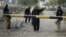 Pakistan security guards police station entrance after attack, Bannu, Dec. 10, 2012.