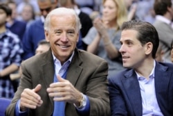 FILE - Then-Vice President Joe Biden and his son Hunter are pictured at a college basketball game in Washington, Jan. 30, 2010.