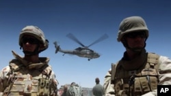 A medevac helicopter lifts off from Camp Nathan Smith in Kandahar city, carrying an unidentified NATO soldier on 9 June 2010