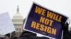 A person displays a sign as labor union activists rally in support of federal workers during a protest, with the U.S. Capitol in the background on Capitol Hill in Washington, Feb. 11, 2025. 