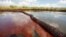 FILE - Oil from the Deepwater Horizon oil spill is seen floating on the surface of the water in Bay Jimmy in Plaquemines Parish, Louisiana, June 26, 2010.