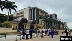 FILE - Journalists are stationed opposite the Federal High Court as they await the arrival of IPOB leader Nnamdi Kanu at the court in Abuja, Nigeria, July 26, 2021. 