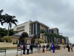 FILE - Journalists are stationed opposite the Federal High Court as they await the arrival of IPOB leader Nnamdi Kanu at the court in Abuja, Nigeria, July 26, 2021.