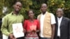 Maseray Kamara, flanked by her fellow burial team members in Freetown, holds the the Bond International Humanitarian Award, given to burial teams from across Sierra Leone for their contributions to stopping the spread of the Ebola virus, June 5, 2015.