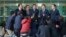 Chung Ki-sup, top center, the head of the council of South Korean companies operating in the Kaesong factory park, speaks to the media after returning from North Korea's Kaesong Industrial Complex, at the Inter-Korean Transit Office near the border villag