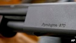 In this Thursday, March 1, 2018, photo The Remington name is seen etched on a model 870 shotgun at Duke's Sport Shop in New Castle, Pa.