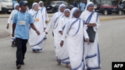 Nuns walk toward the entrance of the Port Moresby International airport on Sept. 6, 2024, prior to the arrival of Pope Francis. Over mountains, by air, and by sea, pilgrims flocked to the capital ahead of Pope Francis's arrival on Sept. 6 on a landmark four-day visit.