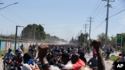 Demonstrators and disgruntled police officers protest in Port-au-Prince, Haiti, March 17, 2021. 