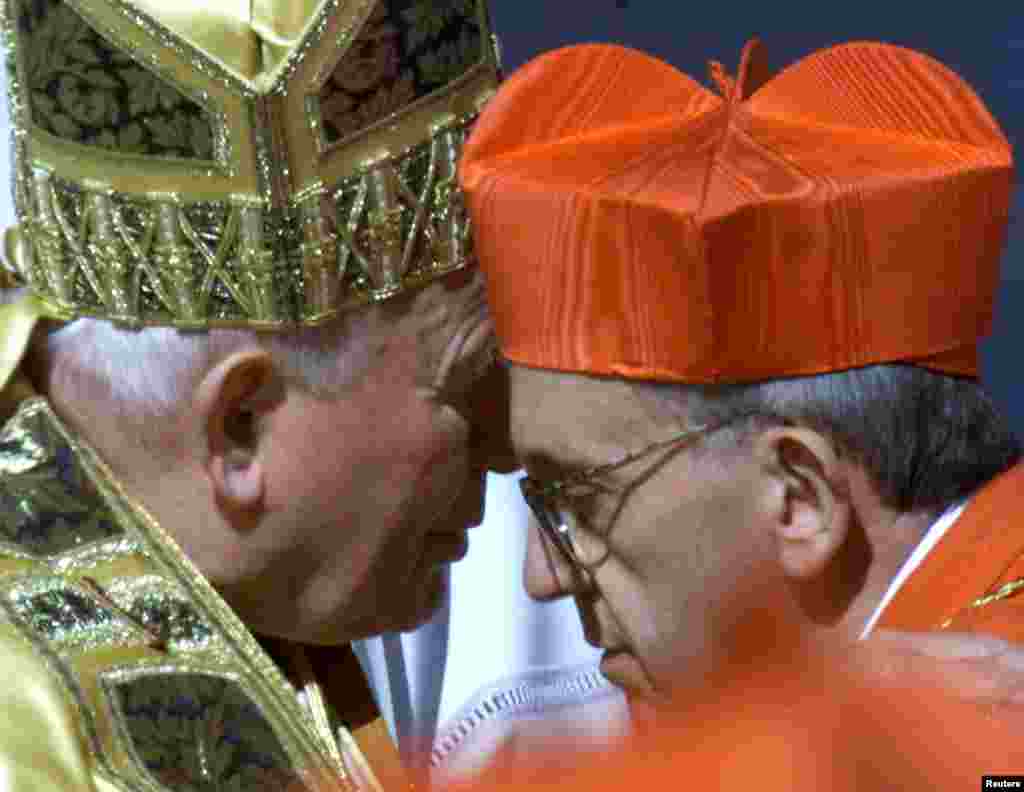New Argentine cardinal Jorge Mario Bergoglio kisses Pope John Paul II after he received the red berretta, a four-cornered red hat, during the Consistory ceremony in Saint Peter's Square February 21, 2001. Putting one of his final stamps on the group that 