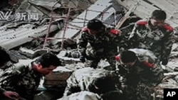 Frame grab taken off Chinese state CCTV shows Chinese military searching through the rubble of collapsed buildings following a strong earthquake in Yushu County in northwest China's Qinghai province, 14 Apr 2010