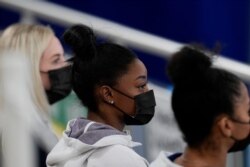 United States gymnast Simone Biles sits on the stands during the artistic gymnastics women's all-around final at the 2020 Summer Olympics, July 29, 2021, in Tokyo, Japan.