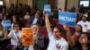 Members of immigration advocacy groups react as Los Angeles City Council votes to enact an ordinance to prohibit city resources from being used for immigration enforcement in anticipation of potential mass deportations, inside Los Angeles City Hall on November 19, 2024.