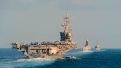 The aircraft carrier USS Abraham Lincoln, left, the air-defense destroyer HMS Defender and the guided-missile destroyer USS Farragut transit the Strait of Hormuz in this Nov. 19, 2019, photo made available by U.S. Navy.