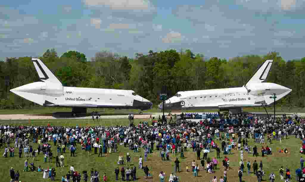 Space Shuttles Enterprise, left, and Discovery meet nose-to-nose at the beginning of a transfer ceremony at the Smithsonian's Steven F. Udvar-Hazy Center in Chantilly, Virginia. (NASA/Smithsonian Institution/Carolyn Russo)