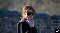 U.S. first lady Melania Trump reacts to photographers as she walks along the Mutianyu Great Wall section in Beijing, China, Nov. 10, 2017. 