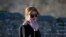 U.S. first lady Melania Trump reacts to photographers as she walks along the Mutianyu Great Wall section in Beijing, China, Nov. 10, 2017. 