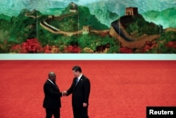 FILE - Ghana's President Nana Akufo-Addo, left, shakes hands with Chinese President Xi Jinping during the Forum on China-Africa Cooperation held at the Great Hall of the People in Beijing, Sept. 3, 2018.