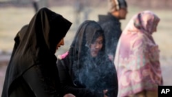 FILE - Pakistani women offer prayers at a shrine in Islamabad, Pakistan, Jan. 13, 2017. 