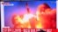 People watch a television news broadcast showing file footage of a North Korean missile test, at a railway station in Seoul on September 28, 2021, after North Korea fired an "unidentified projectile" into the sea off its east coast, according to the South
