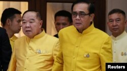 In this file photo taken on April 11, 2019, Thailand's Prime Minister Prayuth Chan-ocha holds hands with Deputy Prime Minister and Defence Minister Prawit Wongsuwan as they take part in water-pouring blessing ahead of Songkran festival at Government House in Bangkok.