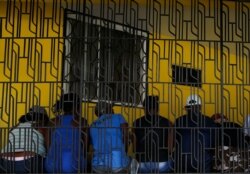 People wait in a long line to get out money at a financial institution in Leogane, Haiti, Oct. 5, 2019.