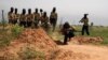 FILE - Rebel fighters are seen training in the northeastern city of Deir Ezzor, March 25, 2014.