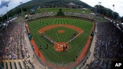 The team from Grandview Little League in Des Moines, Iowa, lines the third base line as the Staten Island, New York, team is introduced in Lamade Stadium before a baseball game in U.S. pool play at the Little League World Series baseball tournament in South Williamsport, Pa., Aug. 16, 2018. 