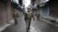 Indian paramilitary soldiers patrol during a curfew in Srinagar, India, February 15, 2013. 