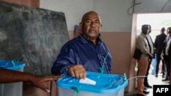 FILE —Incumbent Comoros President and candidate for the Convention for the Renewal of the Comoros party, Azali Assoumani, casts his ballot at the Mitsudje public school polling station in Moroni on January 14, 2024.