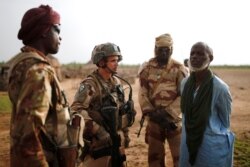 FILE - Malian Armed Forces and French soldiers conduct an area control operation in the Gourma region during Operation Barkhane in Ndaki, Mali, July 29, 2019.