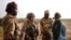 FILE - Malian Armed Forces (FAMa) and French soldiers of the "Belleface" Desert Tactical Group (GTD) conduct an area control operation in the Gourma region during the Operation Barkhane in Ndaki, Mali, July 29, 2019.