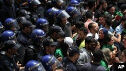 Students face police officers during a protest in Algiers, May 21, 2019.