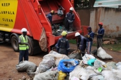 Kampala Capital City Authority workers remove garbage under a campaign encouraging people to keep neighborhoods clean, in Makindye-Lukuli, Uganda, July 10, 2019.