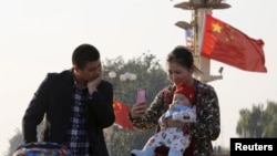 중국 베이징 톈안먼광장에서 아이와 시간을 보내는 부부. (자료사진)