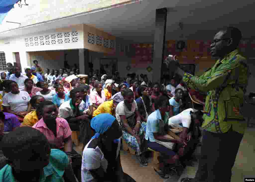 FILE - Youths attend a talk on sexual and domestic violence and HIV/AIDS prevention in Agoe-Nyive, a suburb of Lome.