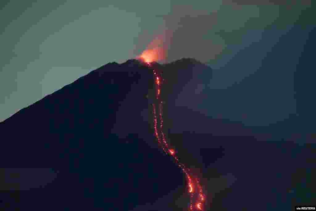 Mount Semeru volcano spews hot lava as it erupts, as seen from Oro-oro Ombo village in Lumajang, East Java province, Indonesia. (Credit: Antara Foto)