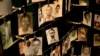 FILE - Family photographs of some of those who died in the Rwandan genocide hang in a display in a memorial center in Kigali, Rwanda, April 5, 2014.