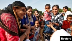 Relatives greet a woman returning from the annual haj pilgrimage in Mecca after arriving at Sardar Vallabhbhai Patel International Airport in Ahmedabad, India, Sept. 20, 2017.