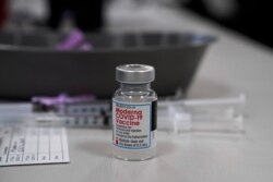 FILE - A vial of Moderna COVID-19 vaccine is seen at an ambulance company in Santa Fe Springs, Calif., Jan. 9, 2021.