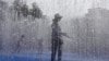 FILE: A woman cools down in a fountain in London, where temperatures could approach 40c. A blanket of hot air stretching from the Mediterranean to the North Sea is giving much of western Europe a powerful heat wave that has ignited fires in Spain and France. 