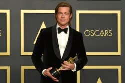 Brad Pitt, winner of the award for best performance by an actor in a supporting role for "Once Upon a Time in Hollywood", poses in the press room at the Oscars