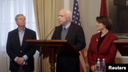 U.S. Senators John McCain (C), Lindsey Graham (L) and Amy Klobuchar attend a news conference during their visit to in Riga, Latvia, Dec. 28, 2016. "We must stand up to Vladimir Putin," McCain said Sunday when the lawmakers visited Tbilisi, Georgia, as part of their tour to reassure U.S. allies and partners in the region.