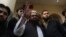 FILE - Hafiz Saeed, head of the Pakistan's Jamaat-ud-Dawa group, waves to supporters at a mosque in Lahore, Pakistan, Nov. 24, 2017.